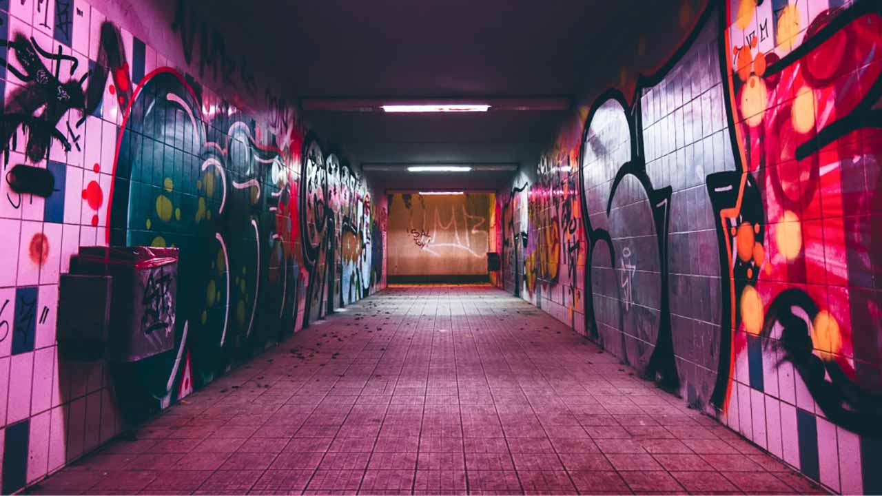 Neon-Tags und Sprühdosen-Spuren auf grauem Beton